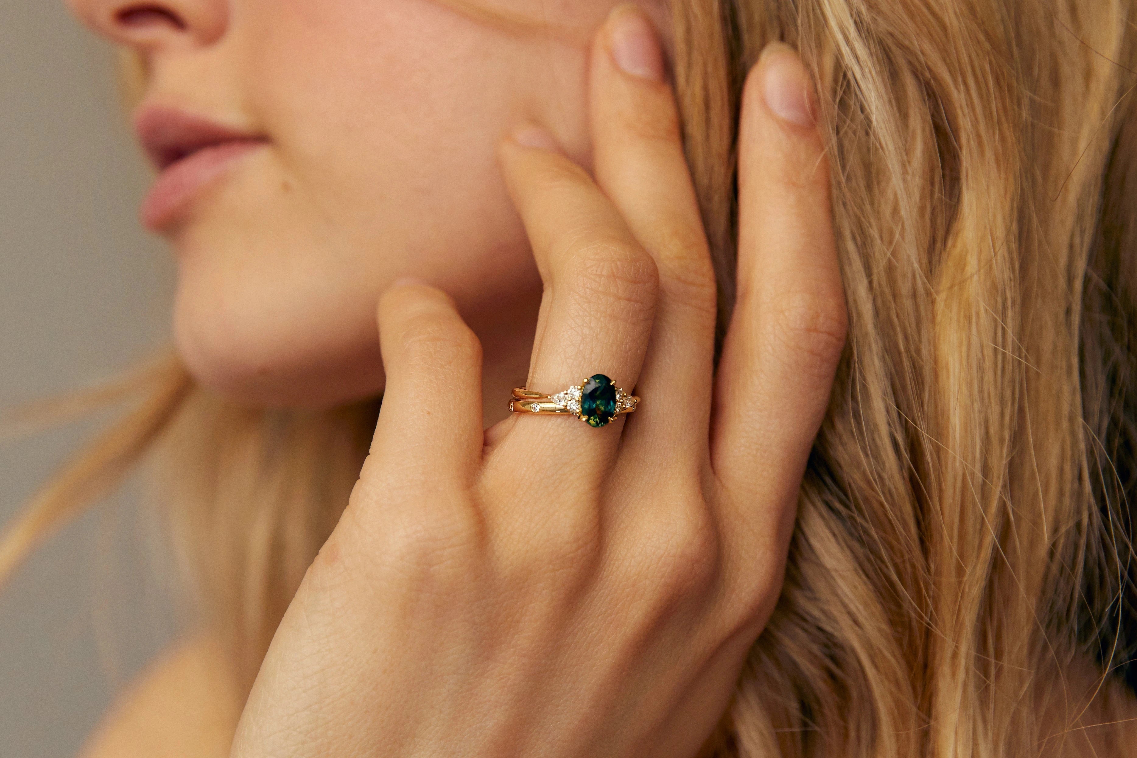 high set engagement ring worn with straight wedding ring