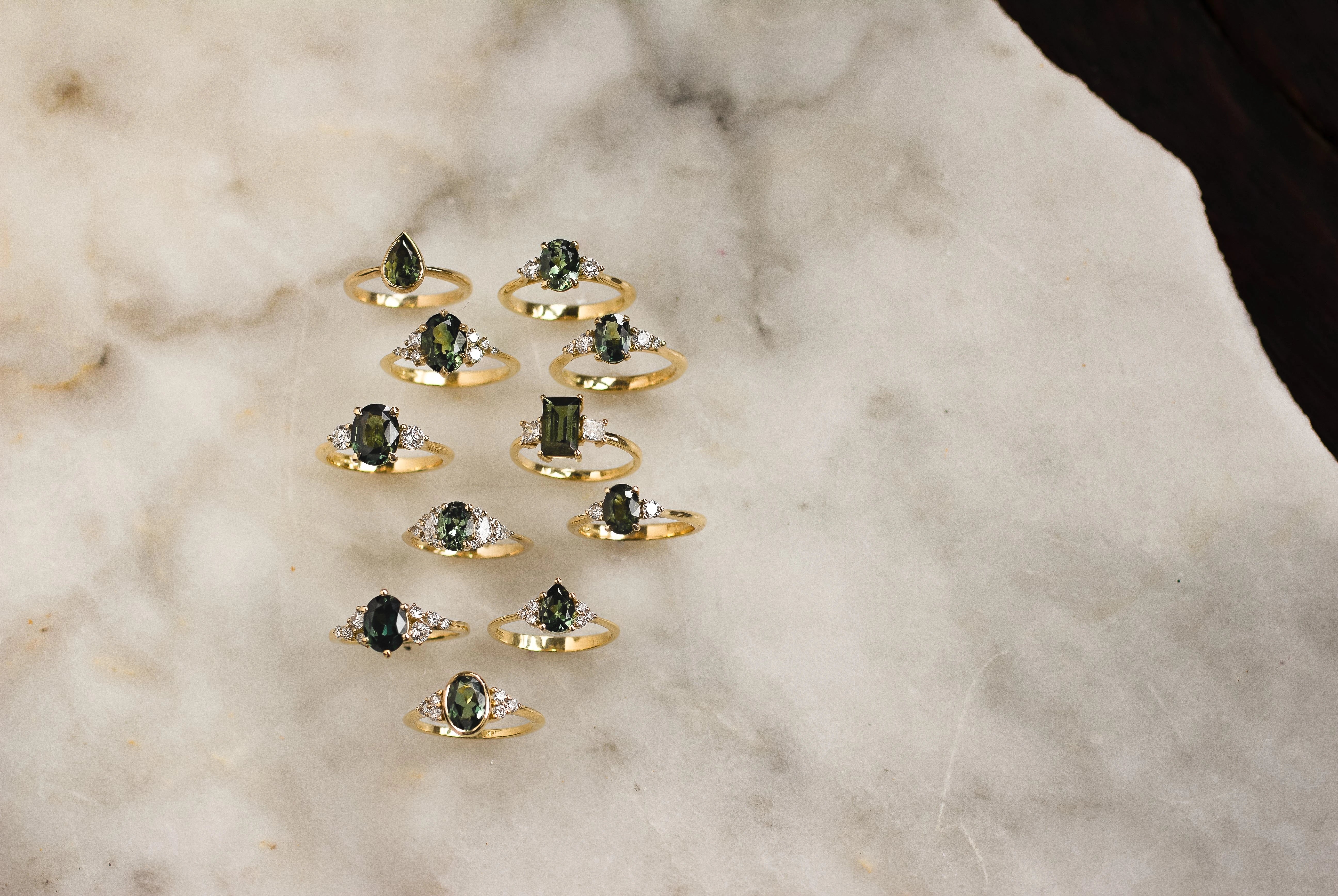 11 green sapphire engagement rings on yellow gold with diamonds
