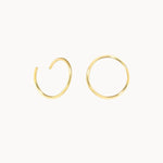 Gold hoop earrings on a white background