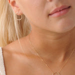 model wearing 9ct gold circle necklace with circle earrings