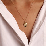 model wearing gold leo necklace