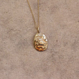 Close up of solid gold taurus necklace pendant