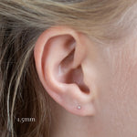 close up of ear wearing white gold diamond studs in 1.5mm size
