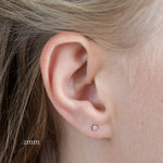 close up of ear wearing white gold diamond studs in 2mm size