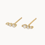 pair of diamond climber earrings in yellow gold featuring 3 diamonds with round claw setting