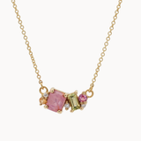 Gold necklace with pink and green sapphires on a white background