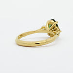 High-Set Elongated Oval Green Sapphire and Diamond Trilogy Engagement Ring back view showing high-set basket