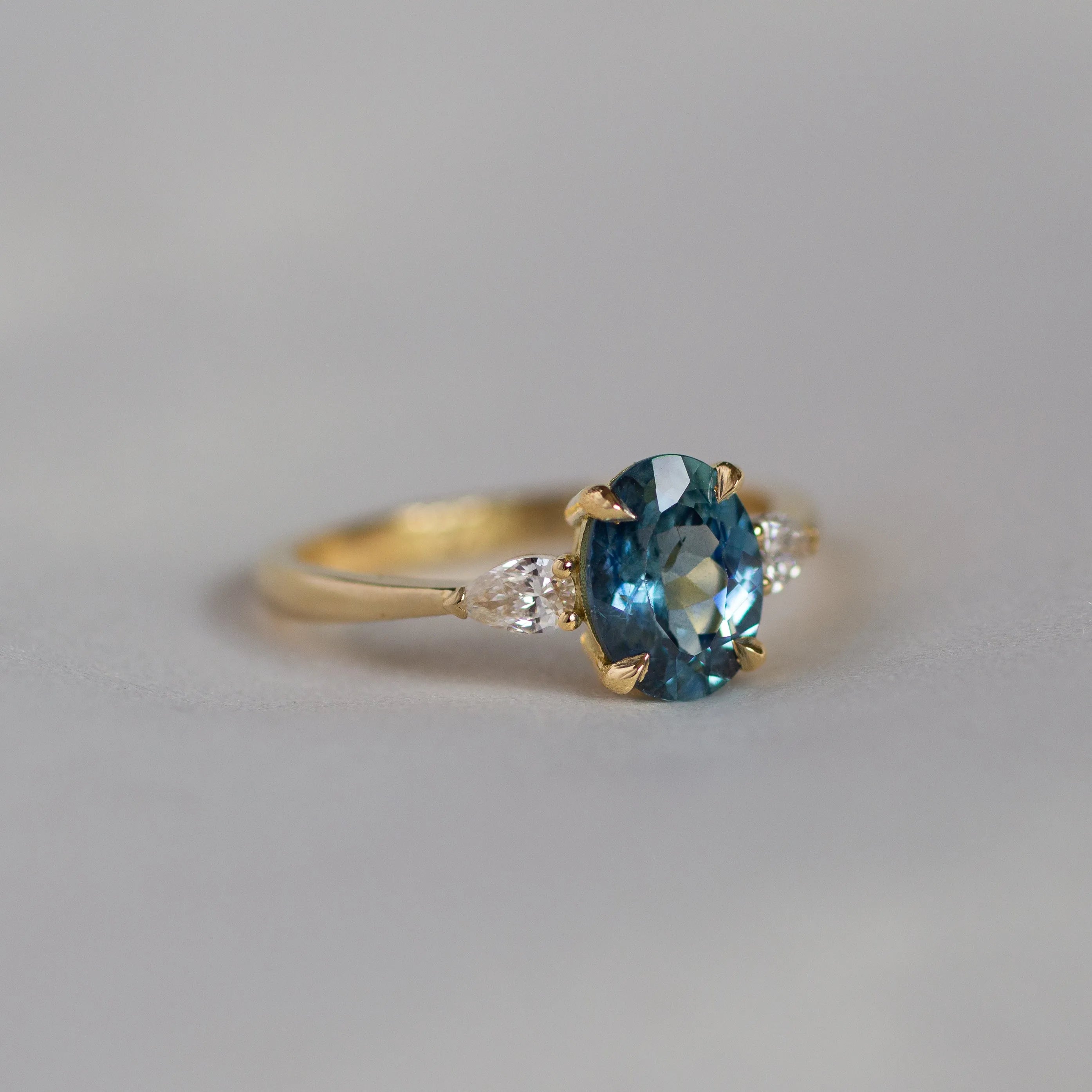 Blue Oval Sapphire Engagement Ring with Pear Accent Diamonds