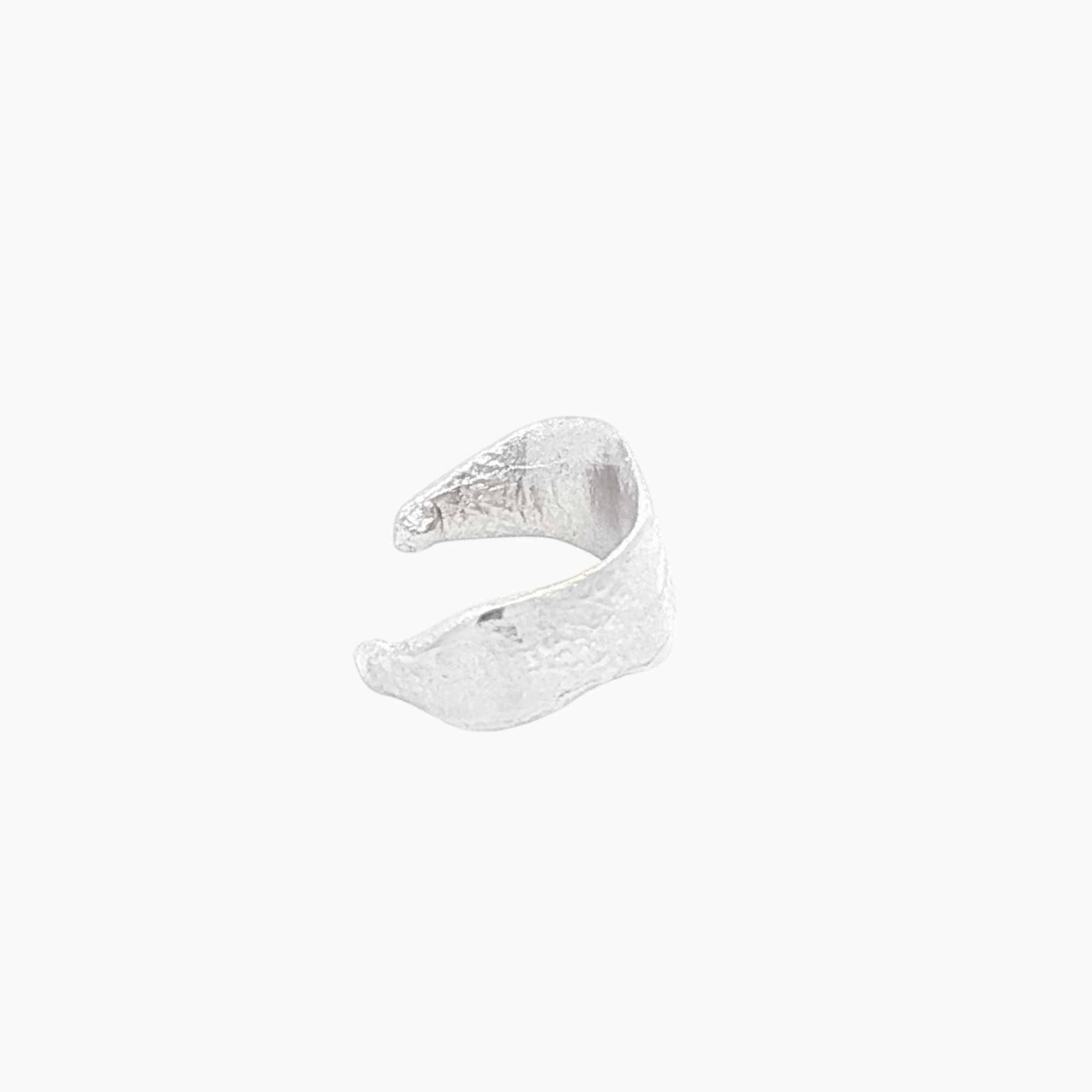 Silver ear cuff side view on a white background