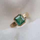 Emerald solitaire wide band engagement ring