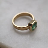 Emerald solitaire wide band engagement ring