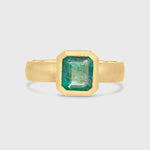 Emerald solitaire wide band engagement ring