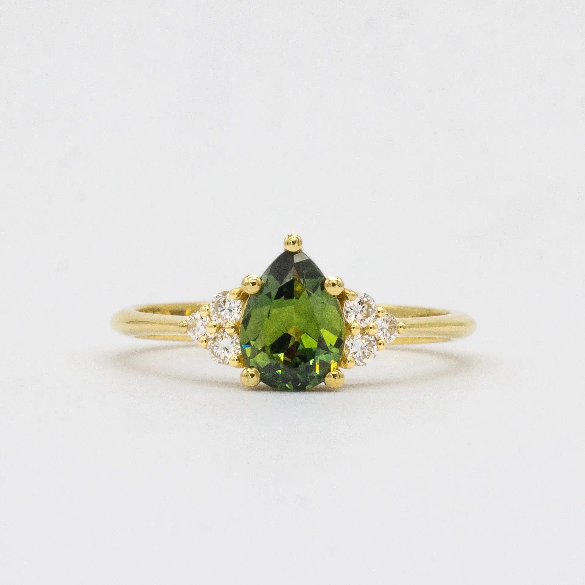 Green Pear Sapphire With Diamond Cluster Detail Engagement Ring