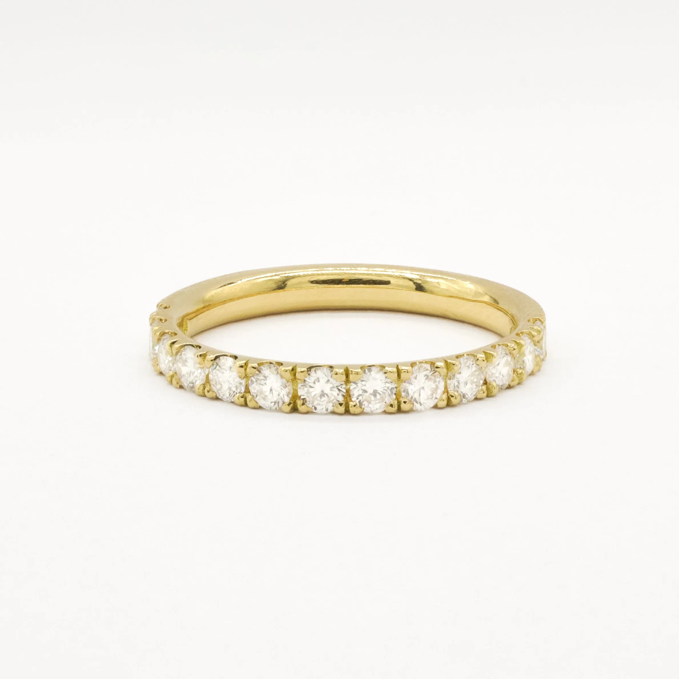 Yellow gold eternity ring with 2.3mm diamonds on a white background