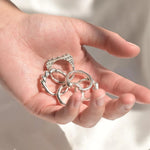 Hand holding silver rings made at the Wild Fawn jewellery workshop in London