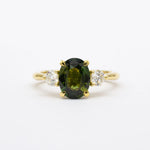 Large green sapphire engagement ring with diamonds