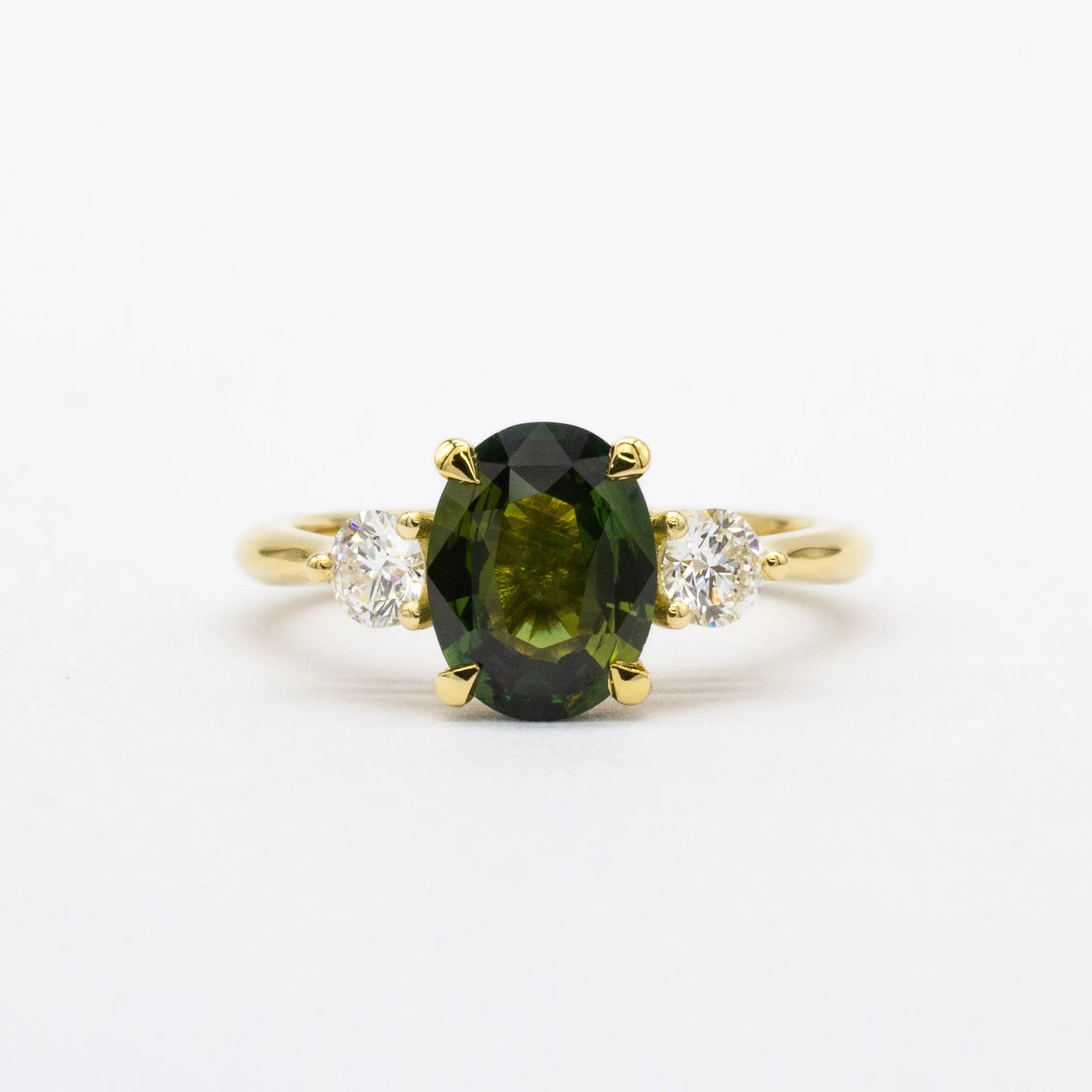 Large green sapphire engagement ring with diamonds