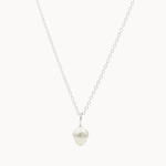 Silver necklace with a small acorn-shaped pendant on a white background
