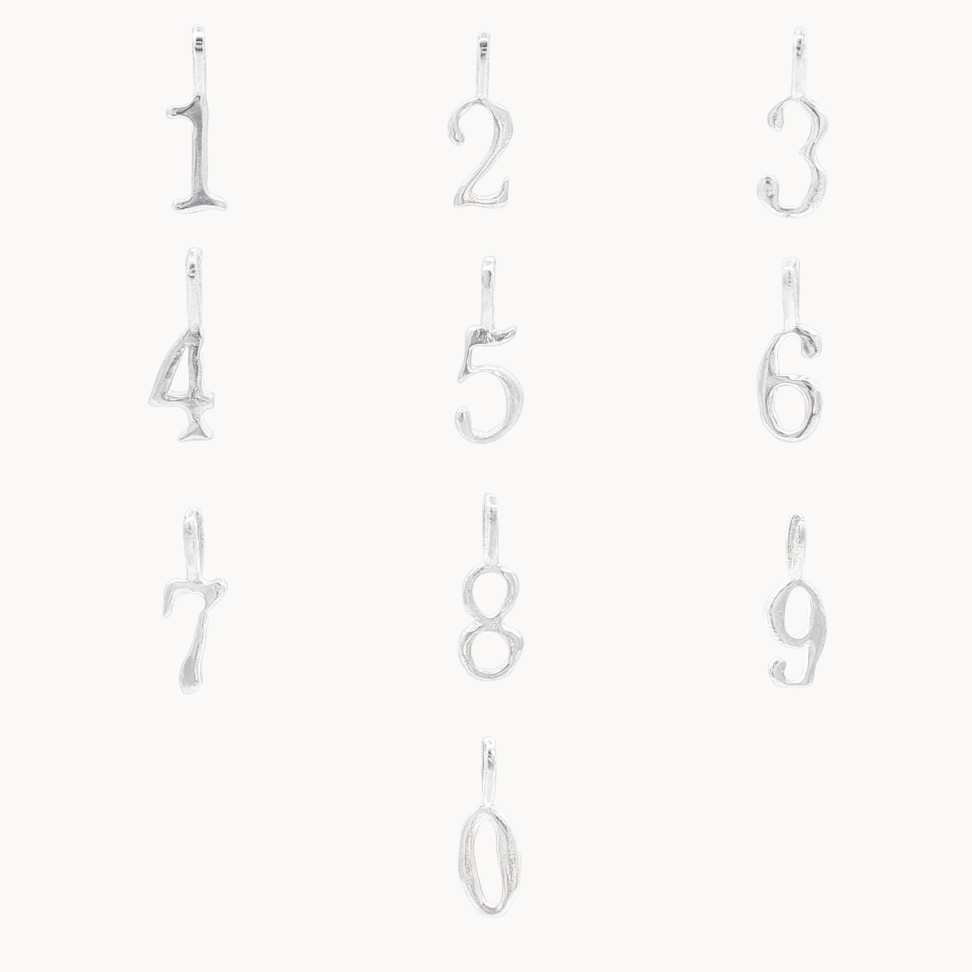 Set of silver number pendants from 0-9 on a white background