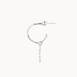 side view of a silver hoop earring with a drop detail on a white background
