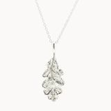 Silver oak leaf pendant necklace on a white background