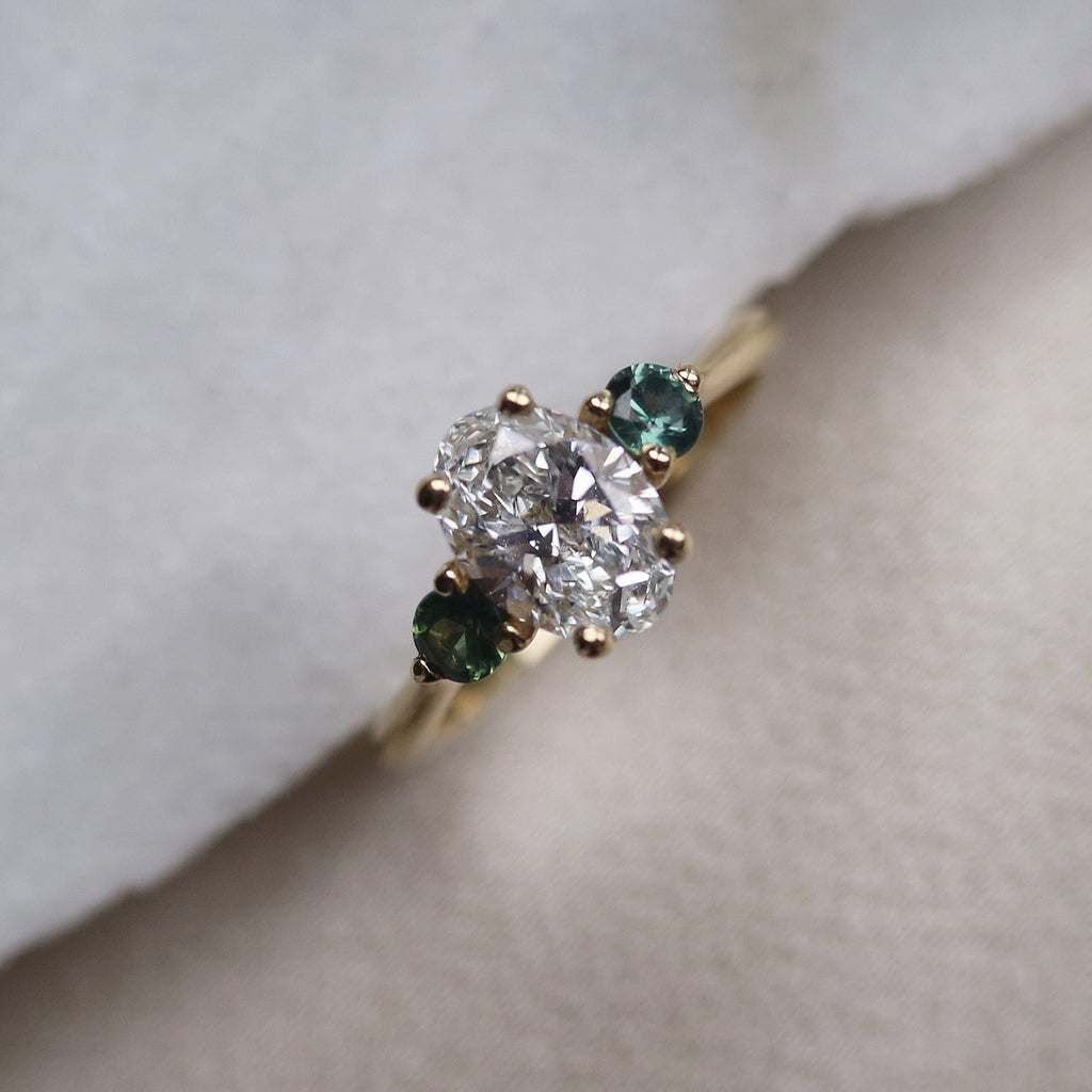 Oval Diamond and Green Tourmaline Trilogy Engagement Ring