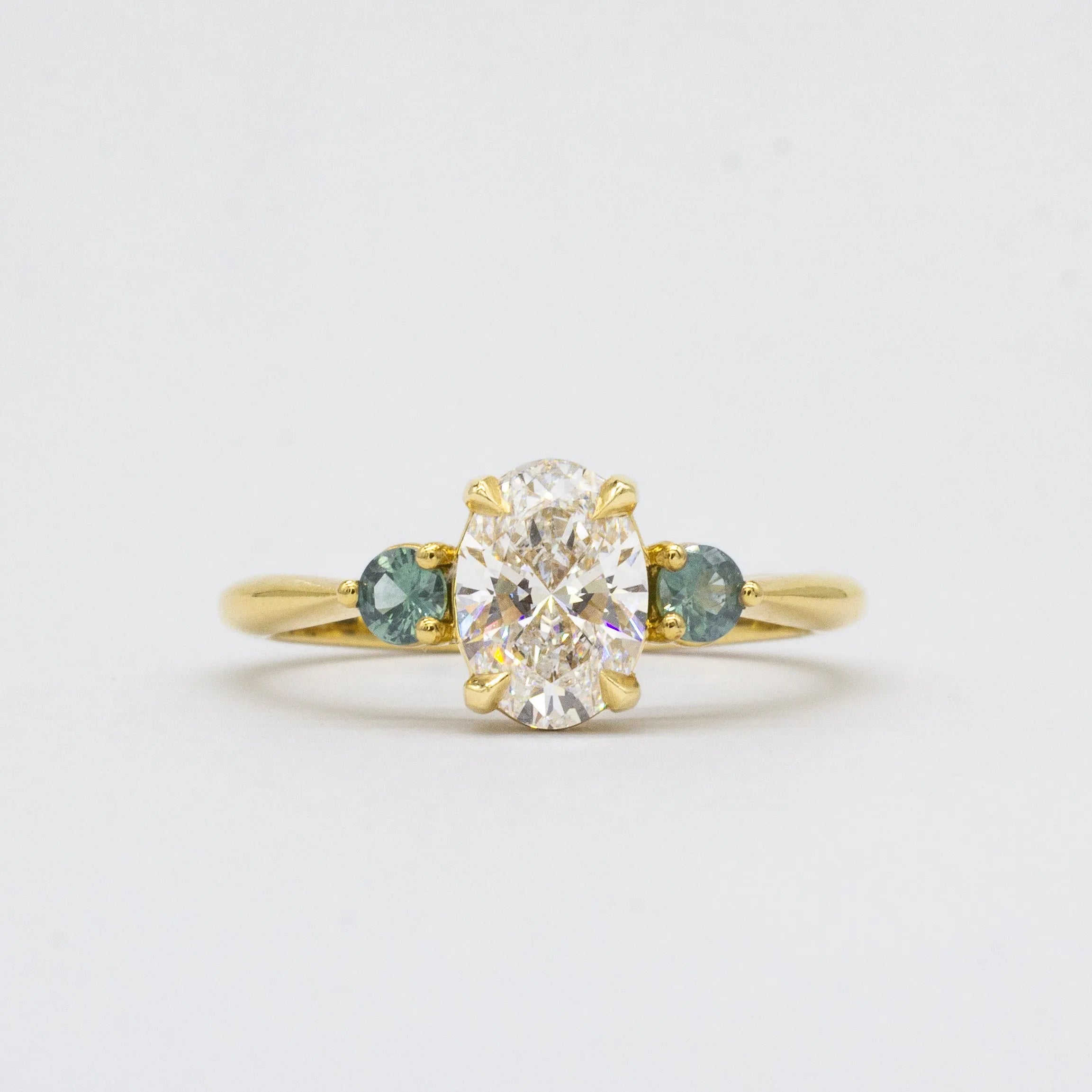 Oval Diamond and Green Tourmaline Trilogy Engagement Ring