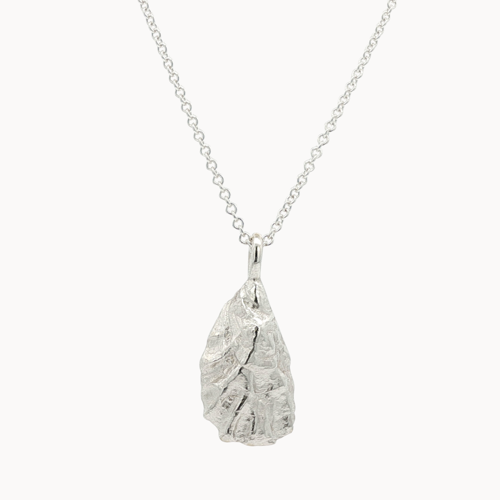 Silver pendant oyster necklace on a white background