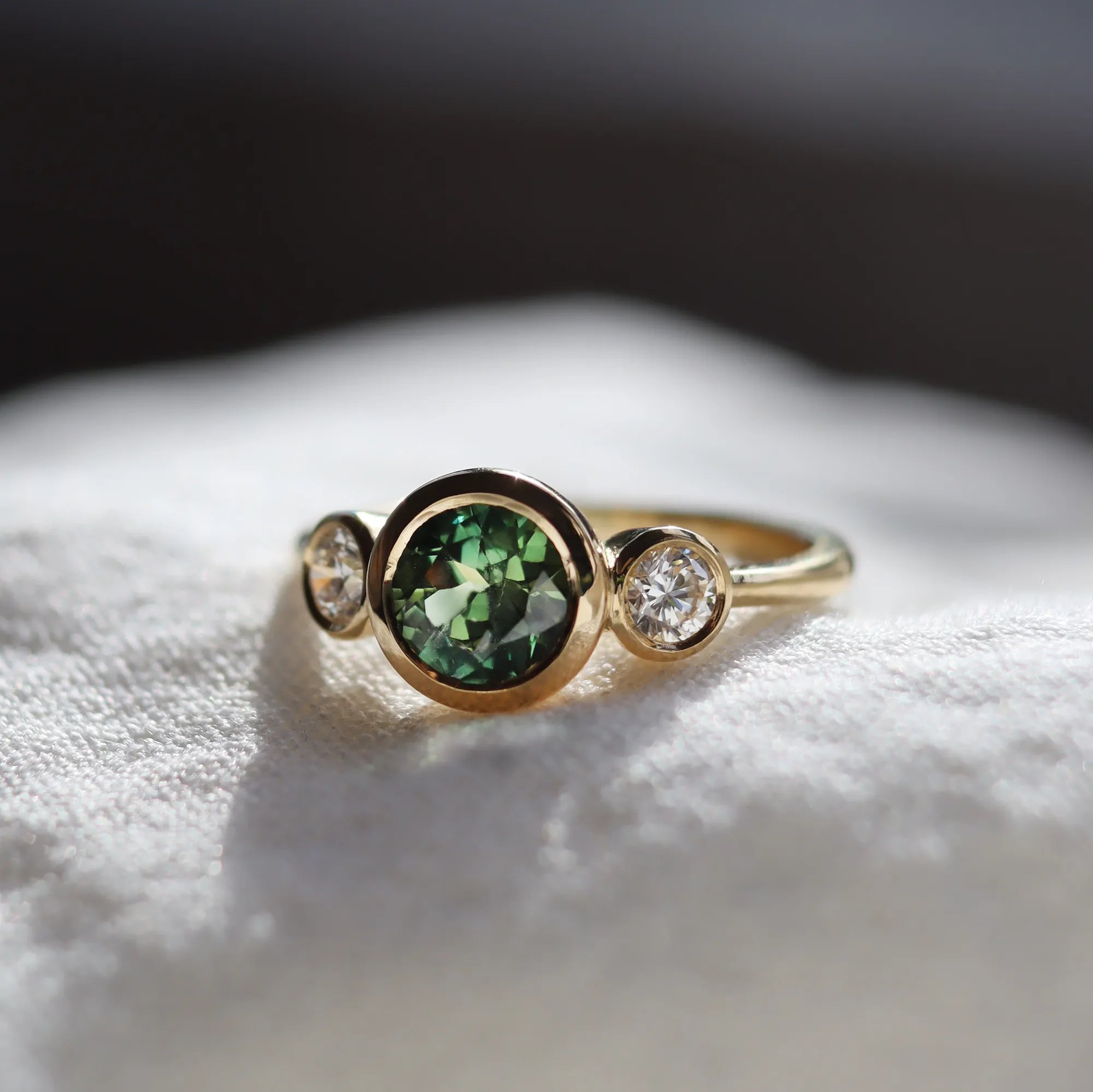 Round bezel set sapphire engagement ring