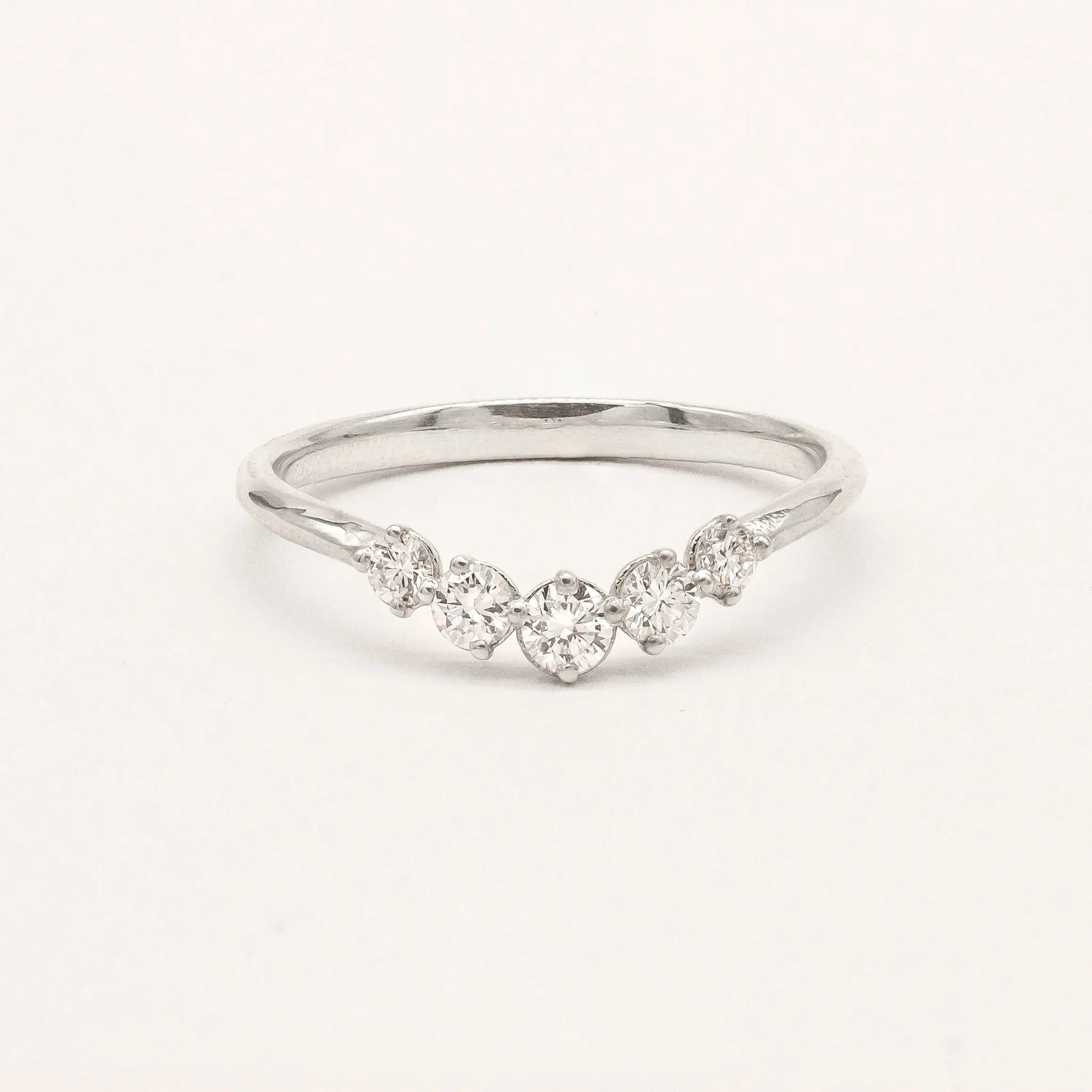 9ct white gold ring with curved diamonds on a light gray background