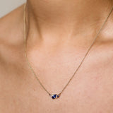 blue and yellow sapphire diamond necklace being worn