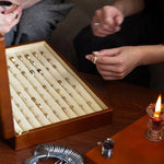 couple sitting infront of wedding ring box trying them on