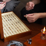 couple sitting infront of wedding ring box trying them on