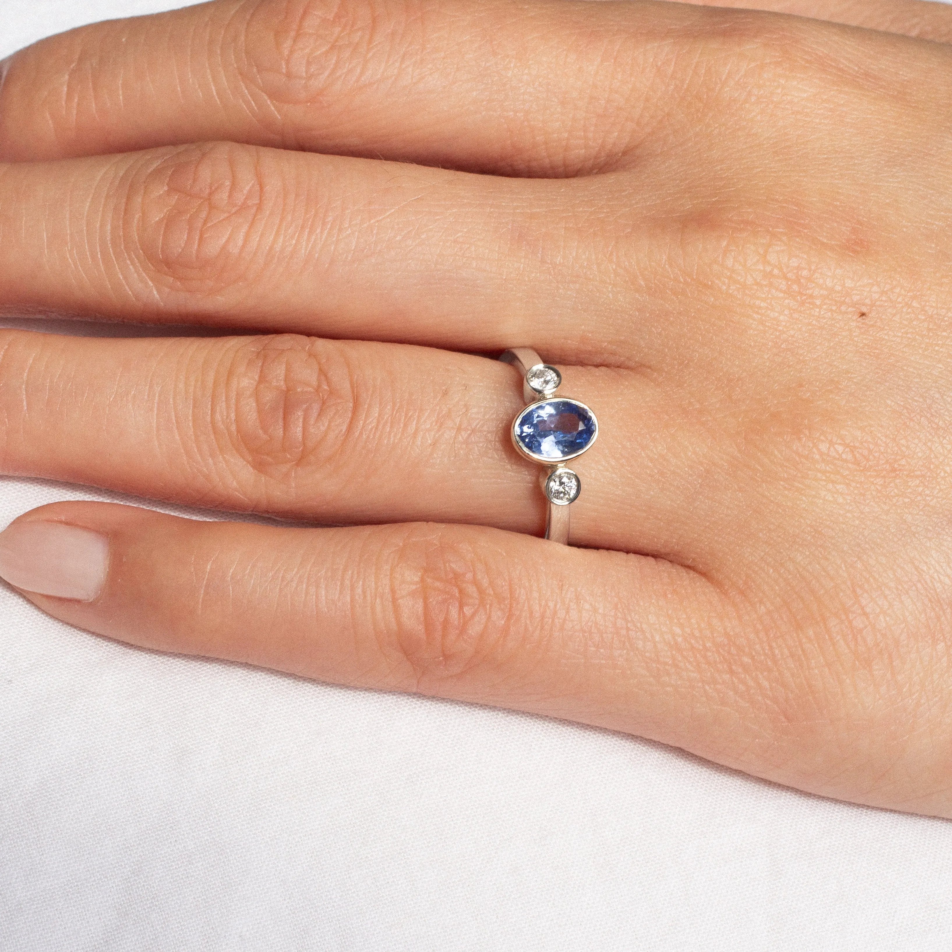 White Gold Bezel Set Blue Sapphire Engagement Ring with Round Diamonds
