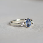 White Gold Bezel Set Blue Sapphire Engagement Ring with Round Diamonds