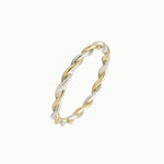 Two-tone twisted ring on a white background