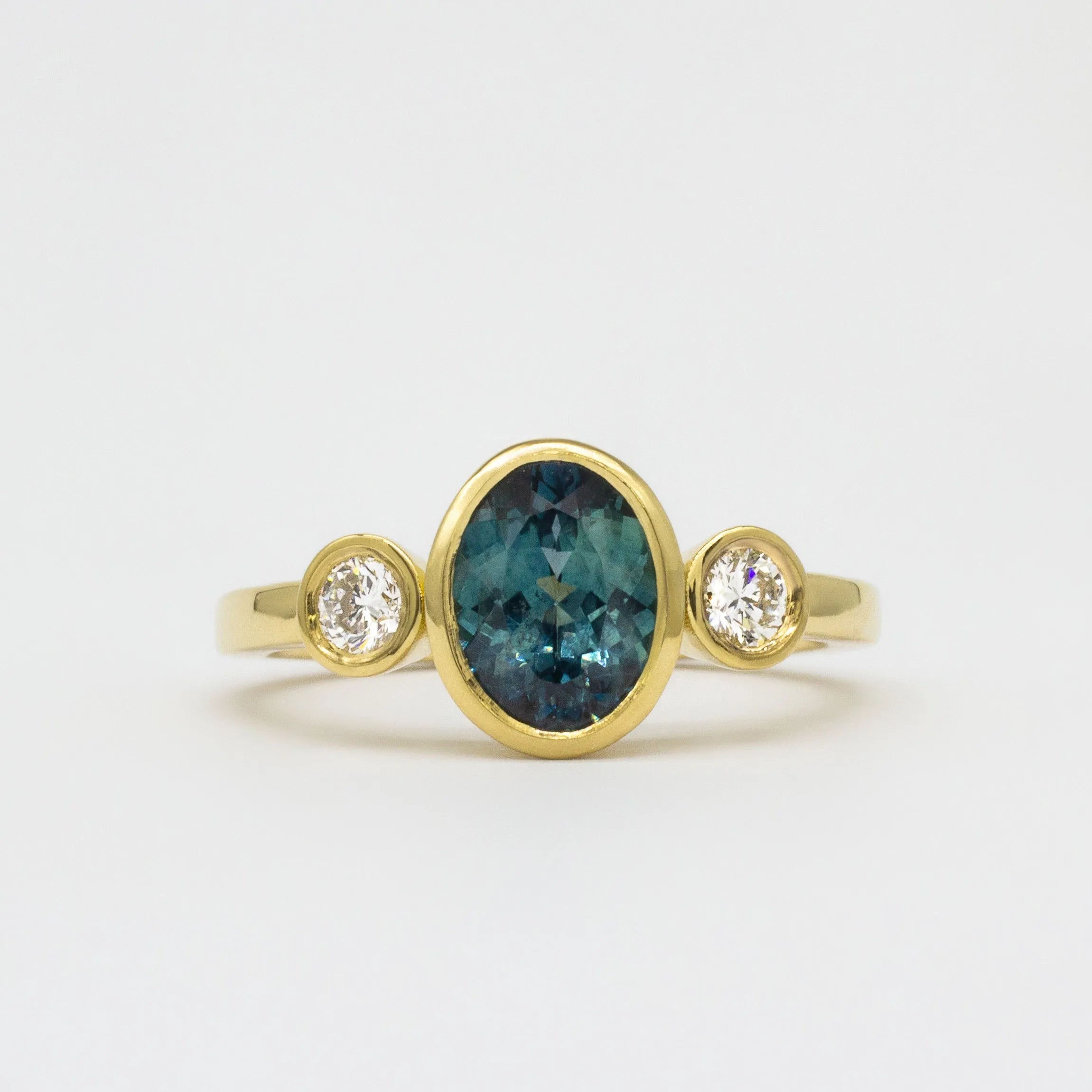 Yellow Gold Bezel Set Blue Sapphire Engagement Ring with Round Diamonds