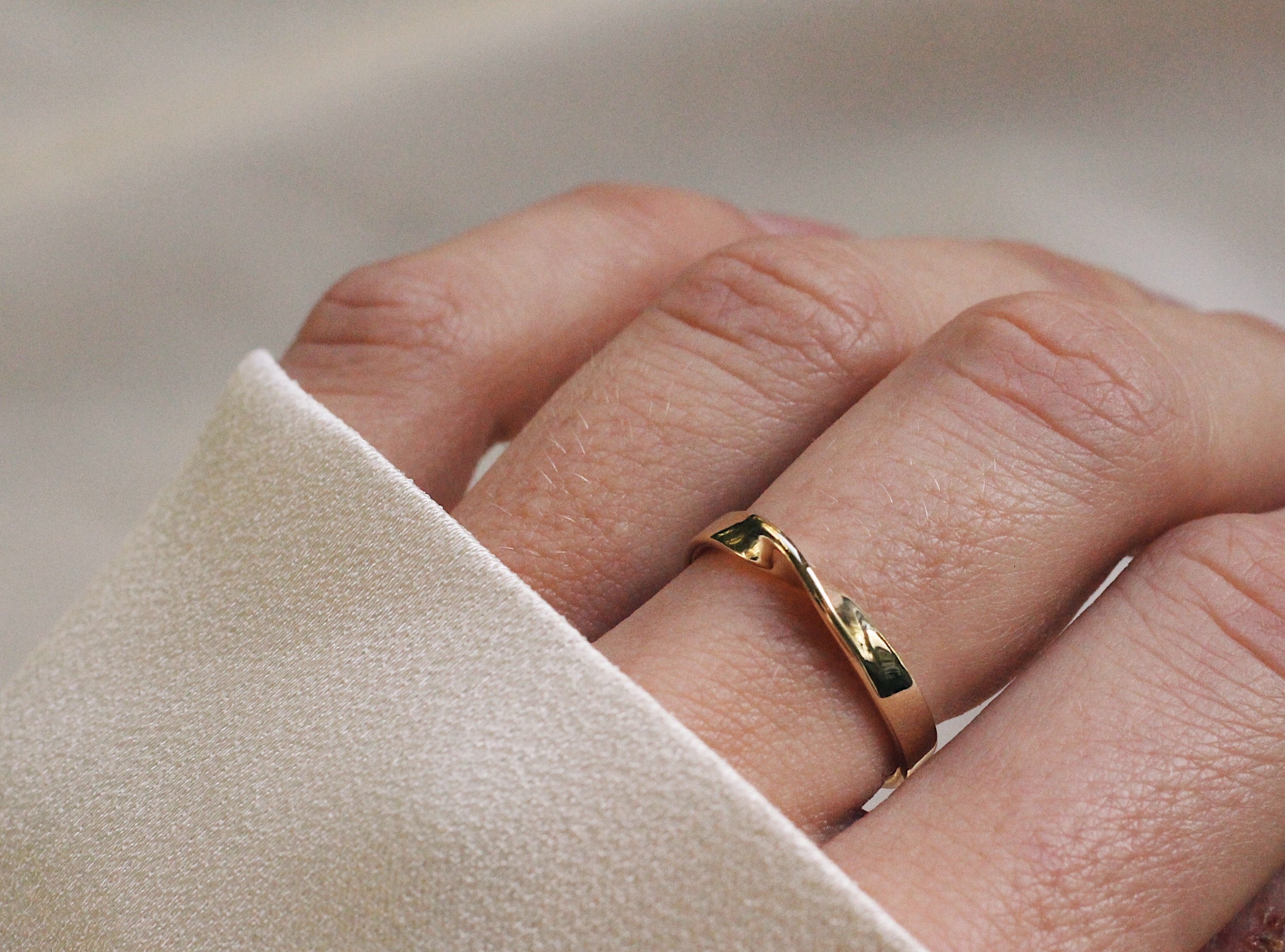 bespoke gold wedding ring with mobius twist design