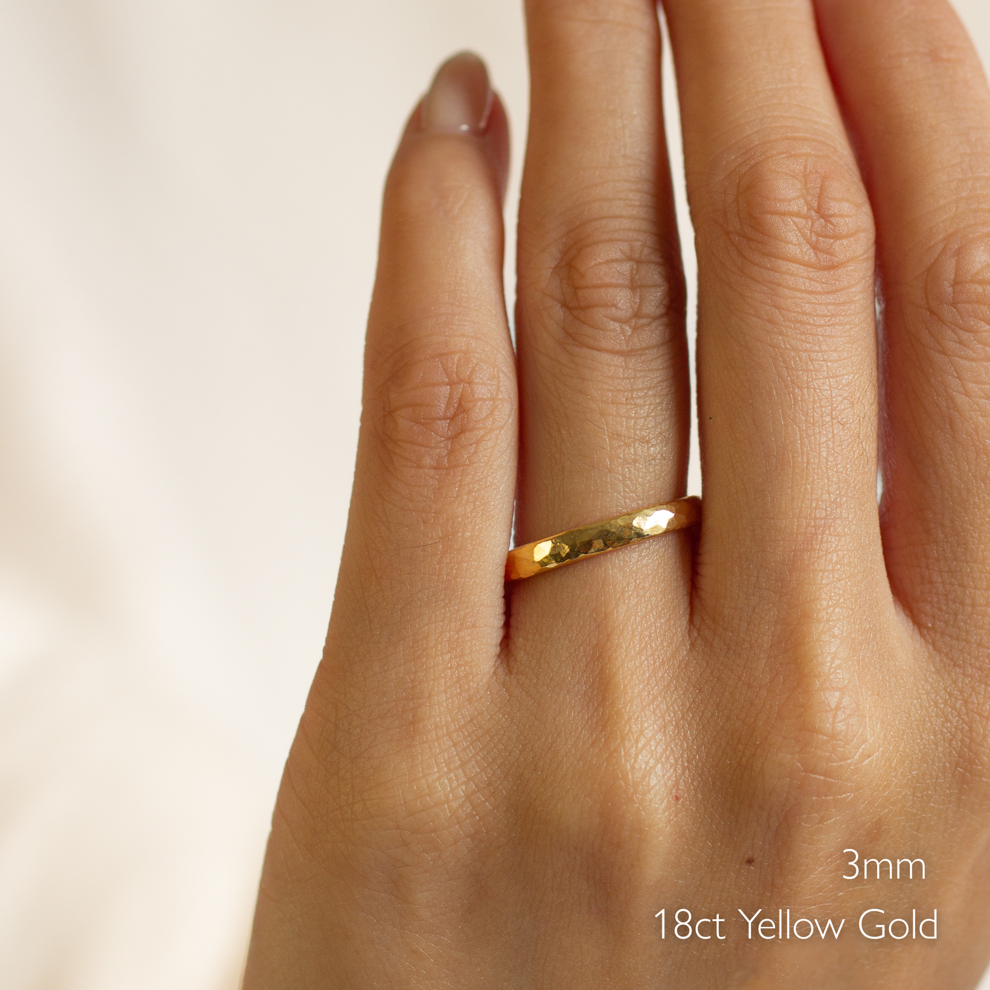 Gold chunky hammered ring on a hand with '3mm 18ct Yellow Gold' text