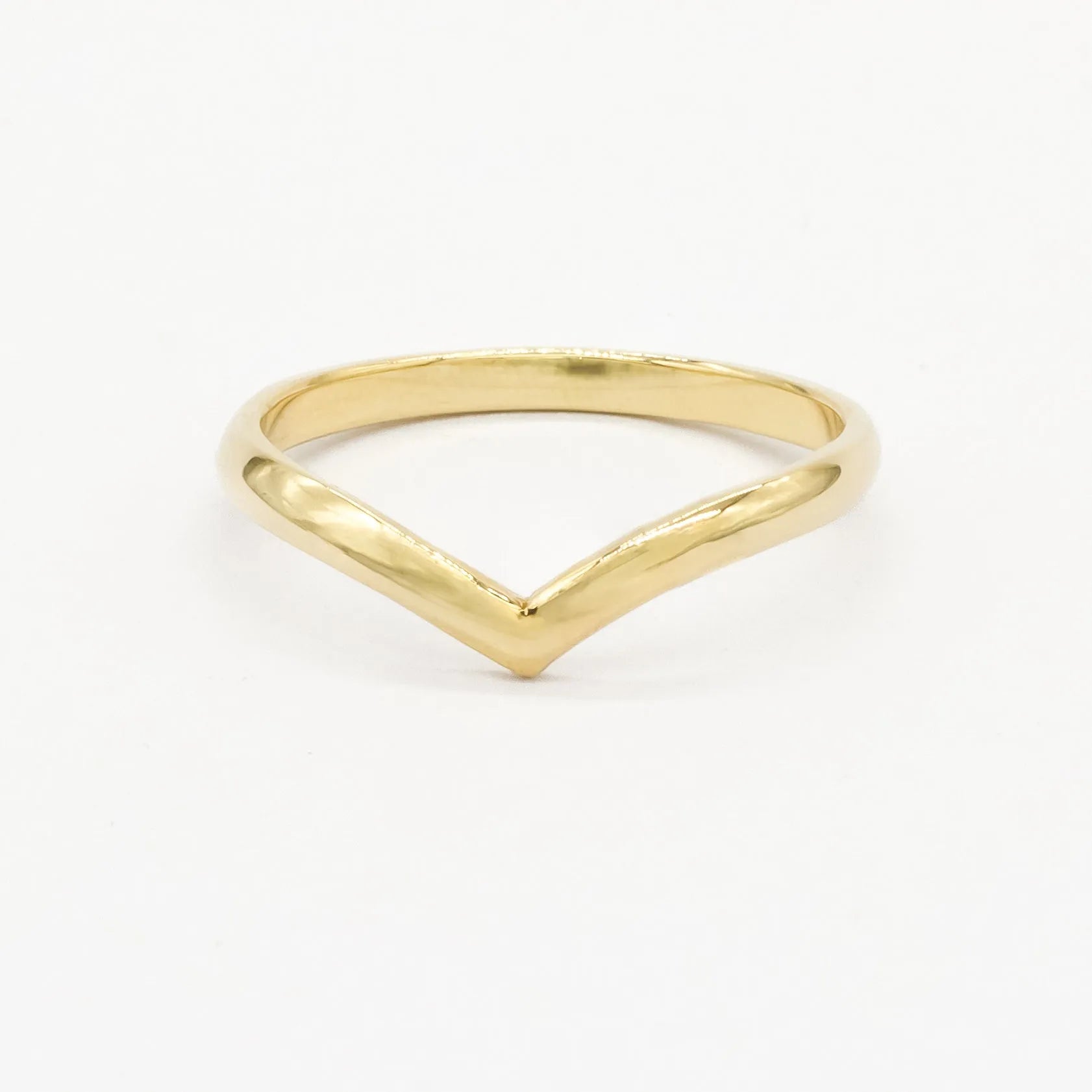 Gold rounded chevron wedding ring with a V-shaped design on a white background