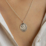 close up of model wearing silver eternally friends oval pendant necklace