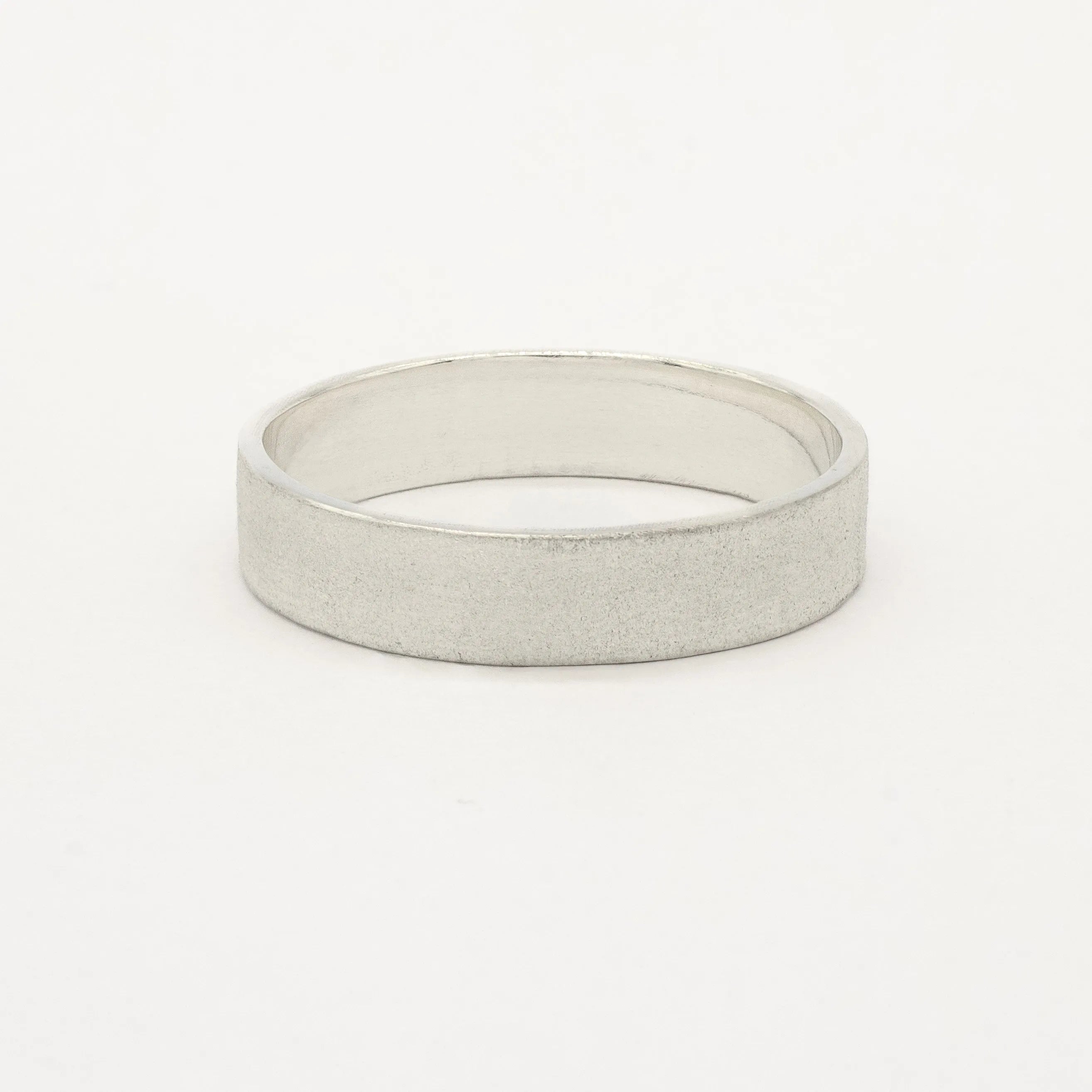 thick 5mm white gold frosted wedding ring in flat shape on a white background