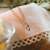 solid gold necklace with 7 pendant on lace fabric