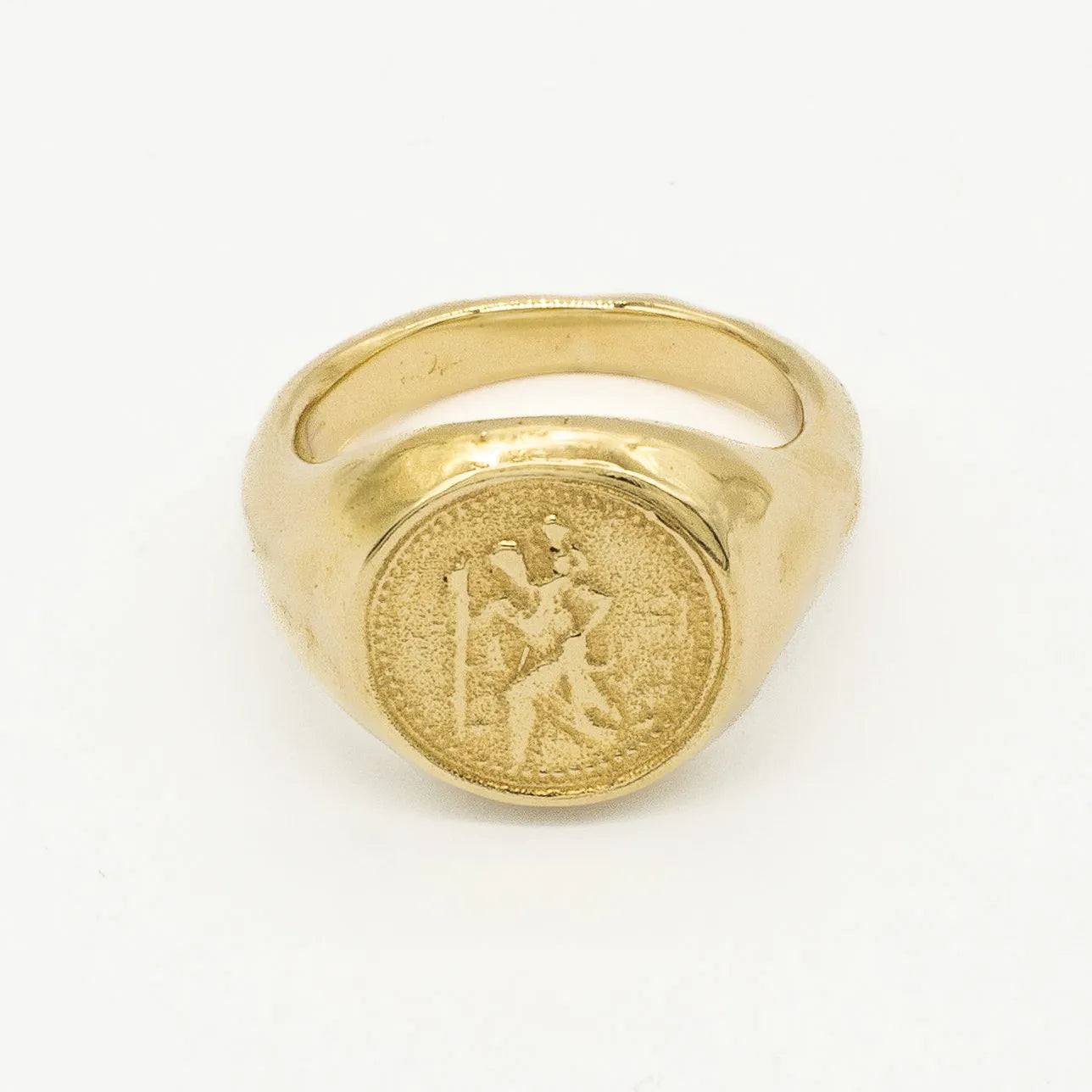 Gold ring with saint christopher engraved design on a white background