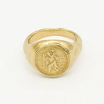 Gold ring with saint christopher engraved design on a white background