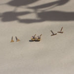 triangle, pebble and bar gold stud earrings with leaf shadow