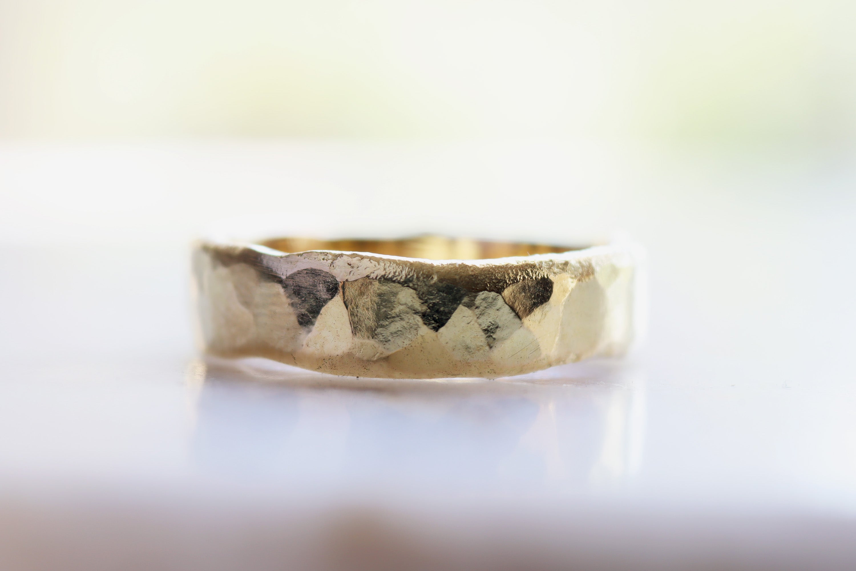 gold bespoke wedding ring with bespoke chunky hammered finish