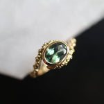 green sapphire engagement ring with octopus design