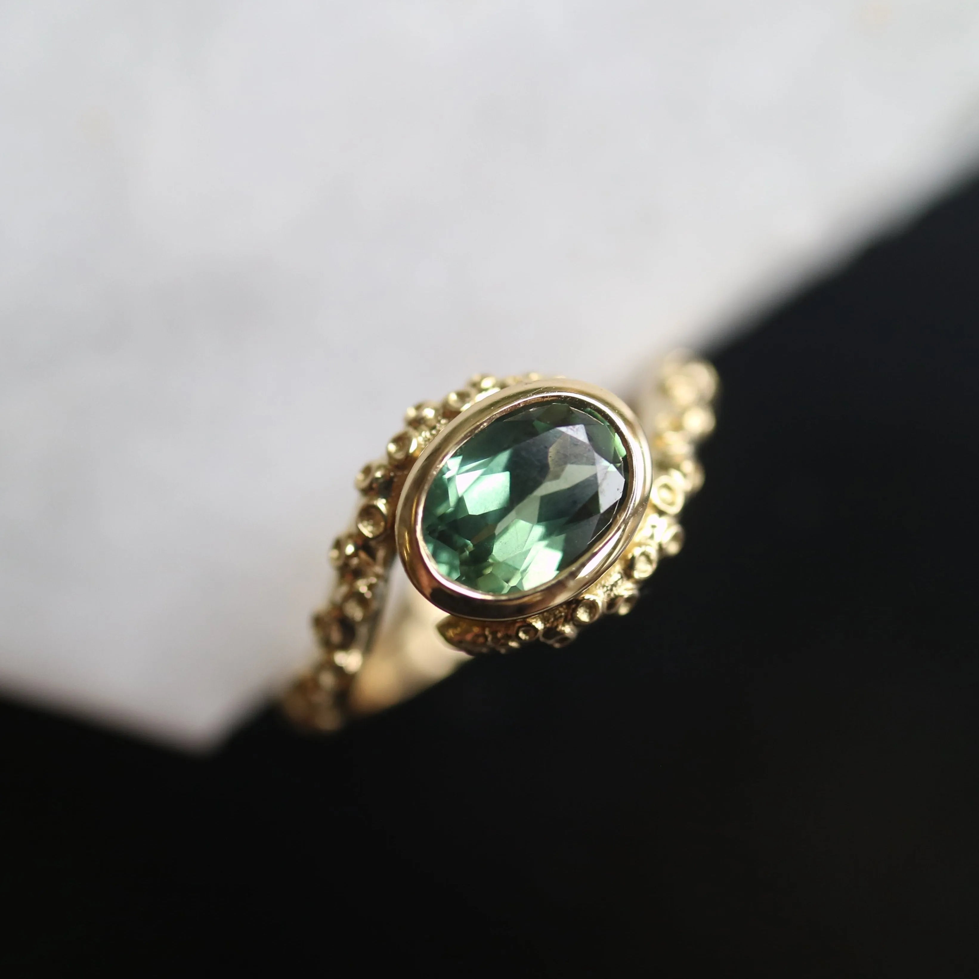 green sapphire engagement ring with octopus design