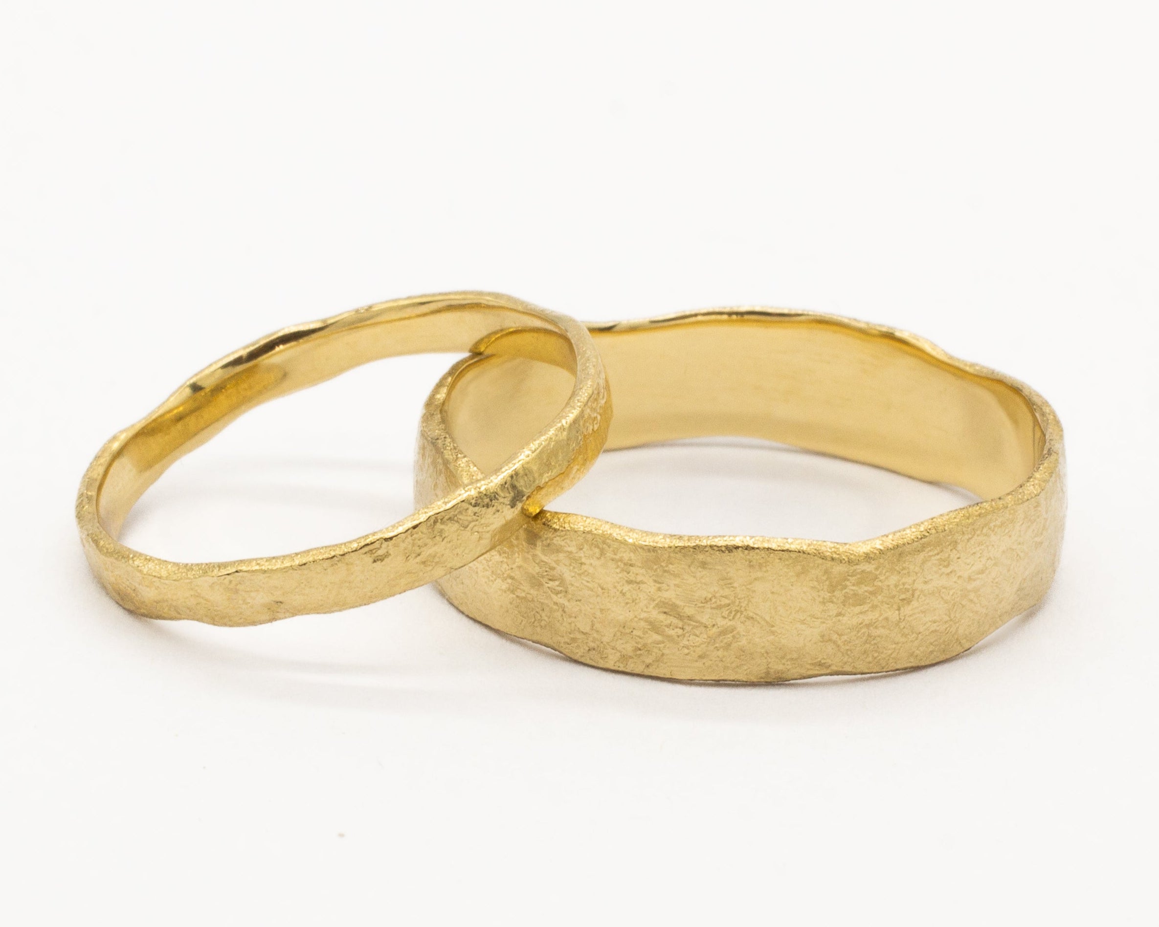 2mm and 5mm wide organic rustic wedding rings on white background